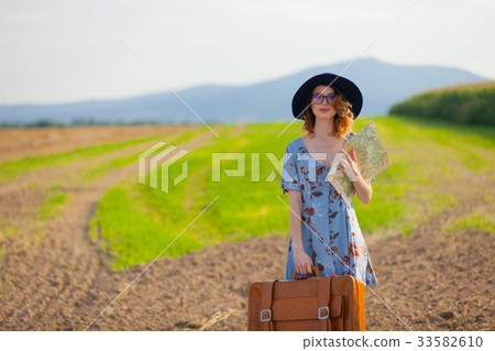woman in dress with map and suitcase woman in dress with map and suitcase 33582610