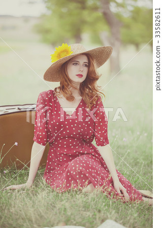 Redhead girl with sunflower at outdoor. Redhead girl with sunflower at outdoor. 33582611