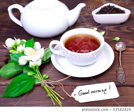 hot black tea in a white cup with a saucer hot black tea in a white cup with a saucer 33582824