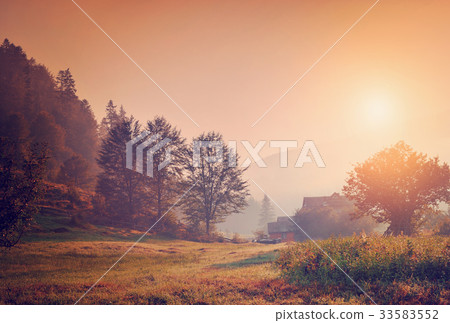 Summer landscape with mountain village in the mist Summer landscape with mountain village in the mist 33583552