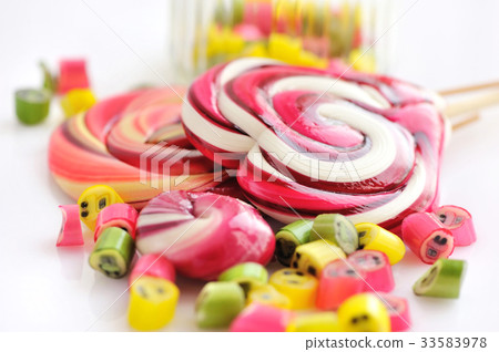 Colorful candies and lollipops on white background 33583978