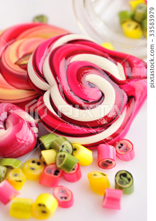 Colorful candies and lollipops on white background 33583979