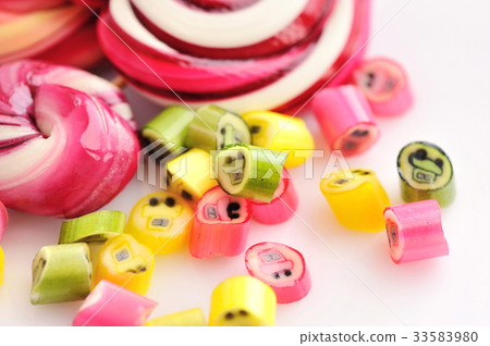 Colorful candies and lollipops on white background Colorful candies and lollipops on white background 33583980