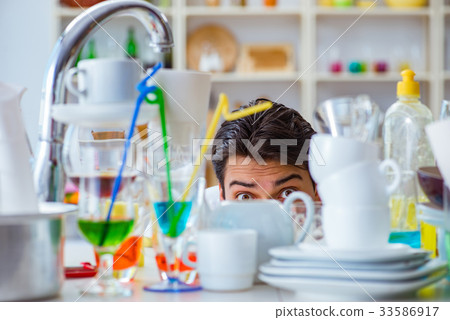 Man frustrated at having to wash dishes 33586917