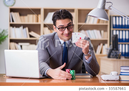 Businessman gambling playing cards at work Businessman gambling playing cards at work 33587661