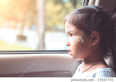 Cute asian little child girl sitting in the car Cute asian little child girl sitting in the car 33587735