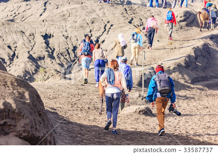 tourist walking through on the craters of Bromo tourist walking through on the craters of Bromo 33587737