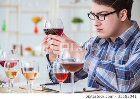 Professional sommelier tasting red wine  33588041