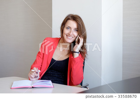 Young happy businesswoman talking on the phone and Young happy businesswoman talking on the phone and 33588670