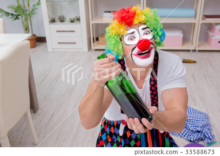 Drunk clown celebrating having a party at home 33588673