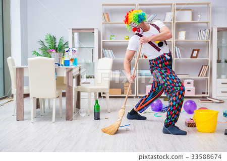Funny clown doing cleaning at home Funny clown doing cleaning at home 33588674
