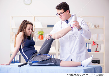 Man doctor taking care of sports injury Man doctor taking care of sports injury 33588852