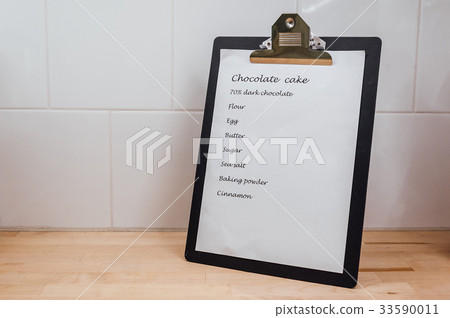 Chocolate cake recipe clip board on the table 33590011