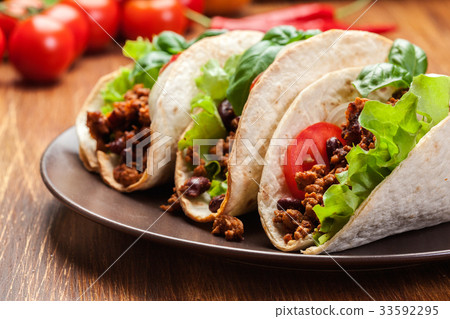 Mexican tacos with minced meat, beans and spices Mexican tacos with minced meat, beans and spices 33592295