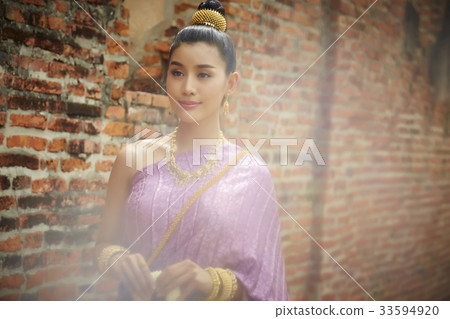 The picture of a beautiful woman smiling in the temple. 33594920