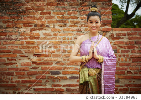 A woman is smiling and greeting with Thai style 33594963