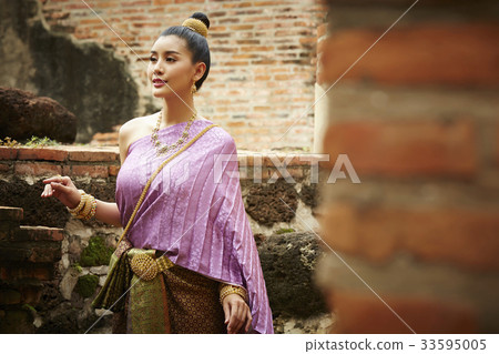 a thai woman is walking and looking at something a thai woman is walking and looking at something 33595005