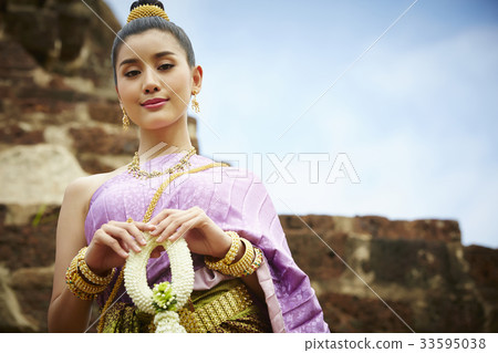 portrait of young woman in Thai traditional costume outdoors portrait of young woman in Thai traditional costume outdoors 33595038