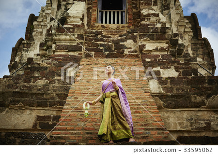 young woman in thai costume is walking in historical temple young woman in thai costume is walking in historical temple 33595062