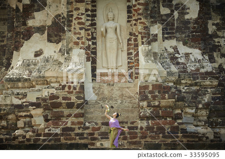 thai woman is posing in front of buddha statue at ayutthaya thai woman is posing in front of buddha statue at ayutthaya 33595095