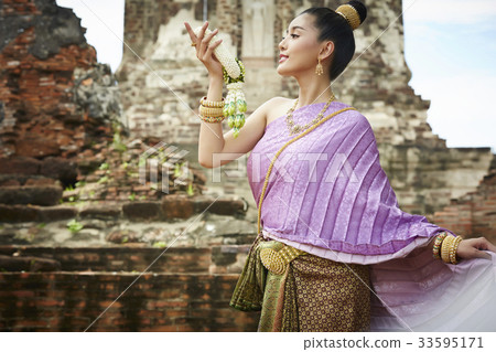 A Thai girl is posing with a garland in a historical park 33595171