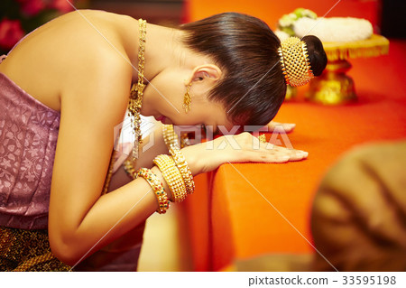 The picture of Thai girl doing kowtow in front of altar The picture of Thai girl doing kowtow in front of altar 33595198
