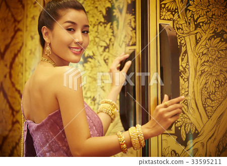 The portrait of a Thai woman standing at the entrance and smiling 33595211