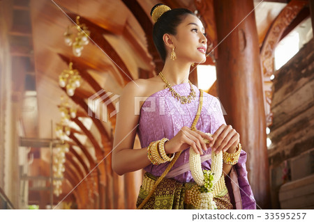 A beautiful woman walks through the corridor while staring at something. A beautiful woman walks through the corridor while staring at something. 33595257