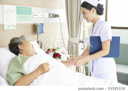 The nurse is holding the patient's hand and smiling 33595319