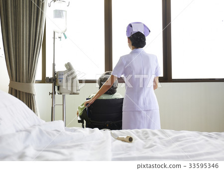 A picture of a nurse and a patient looking outside from a window A picture of a nurse and a patient looking outside from a window 33595346