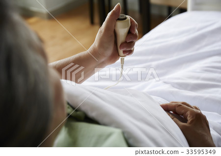 A picture of a patient holding a medical equipment 33595349