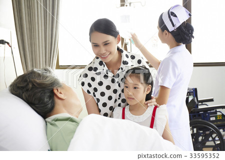 a child and her mother are visiting her grandmother in hospital 33595352