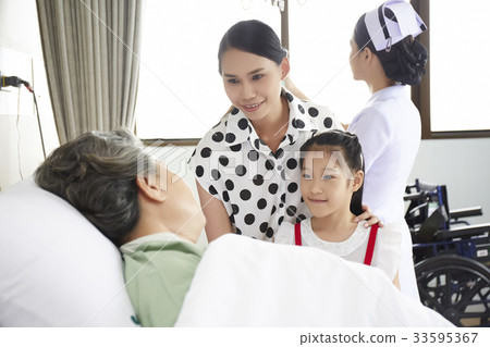 An elderly patient is visited by her relatives in hospital An elderly patient is visited by her relatives in hospital 33595367