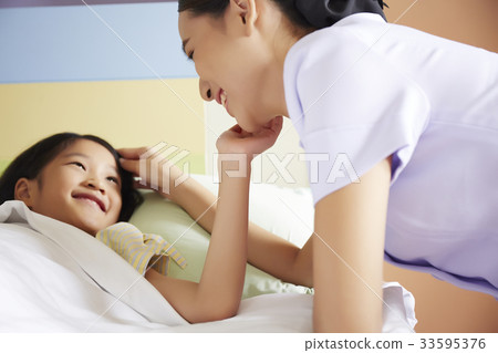A happy moment of a nurse and a kid patient in a hospital A happy moment of a nurse and a kid patient in a hospital 33595376