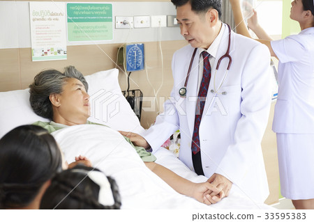 a doctor is motivating the elderly woman in clinic a doctor is motivating the elderly woman in clinic 33595383
