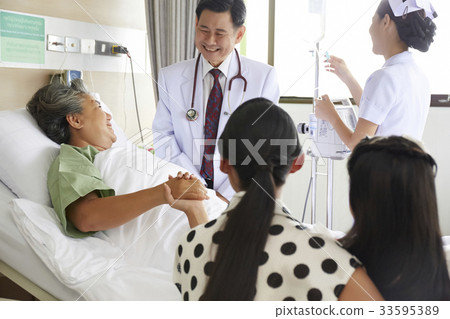 a doctor is smiling and chatting with elderly woman in clinic 33595389