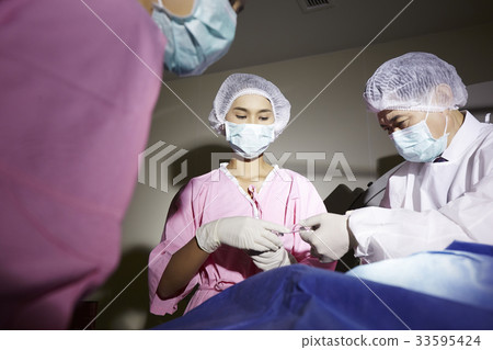 team of surgeons is working in operating room team of surgeons is working in operating room 33595424