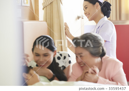 family is caring of a little girl in hospital after recovering surgery 33595437