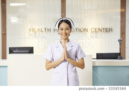An Asian young nurse is greeting with Thai style in hospital. 33595569
