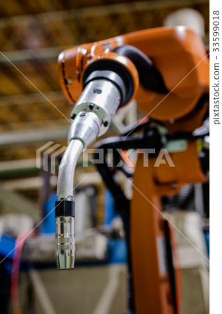 Closeup robot welding arm in car factory Closeup robot welding arm in car factory 33599018