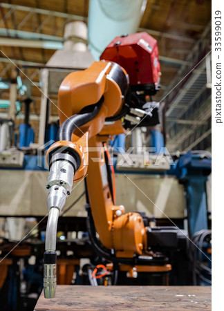 Closeup robot welding arm in factory Closeup robot welding arm in factory 33599019