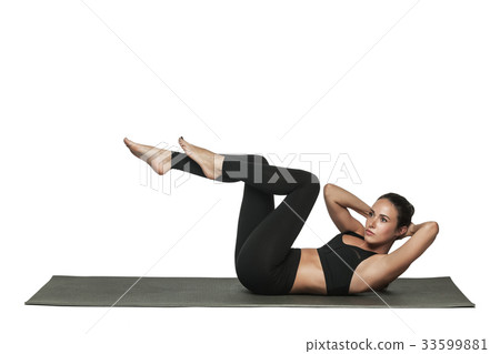 Woman exercising on yoga mat. Isolated on white. 33599881