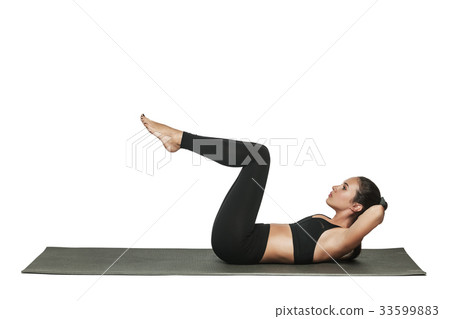 Woman exercising on yoga mat. Isolated on white. 33599883