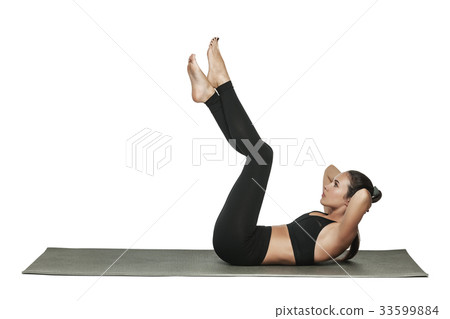 Woman exercising on yoga mat. Isolated on white. 33599884