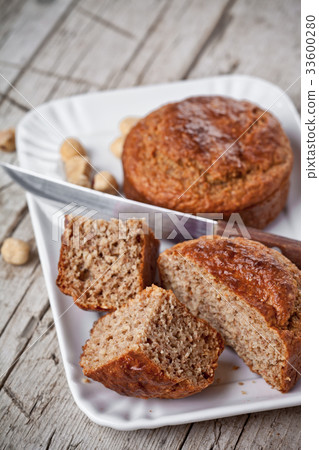 sliced fresh buns, old knife and hazelnuts 33600280