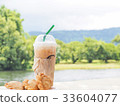 ice coffee with curry on wooden table. 33604077