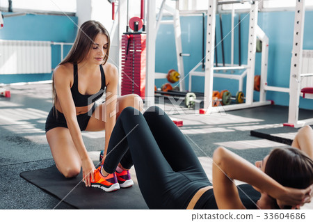 Teen girl working out in the gym coach trains 33604686