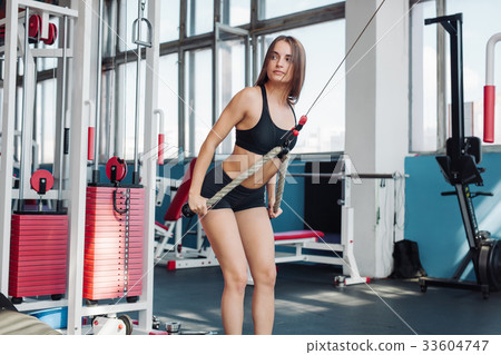 fitness woman exercise with Crossover machine fitness woman exercise with Crossover machine 33604747
