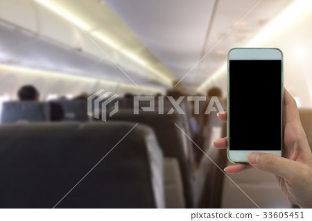 Woman use your phone in airplane background Woman use your phone in airplane background 33605451