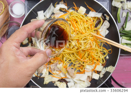Chef pouring soy sauce for cooking Yakisoba noodle Chef pouring soy sauce for cooking Yakisoba noodle 33606294
